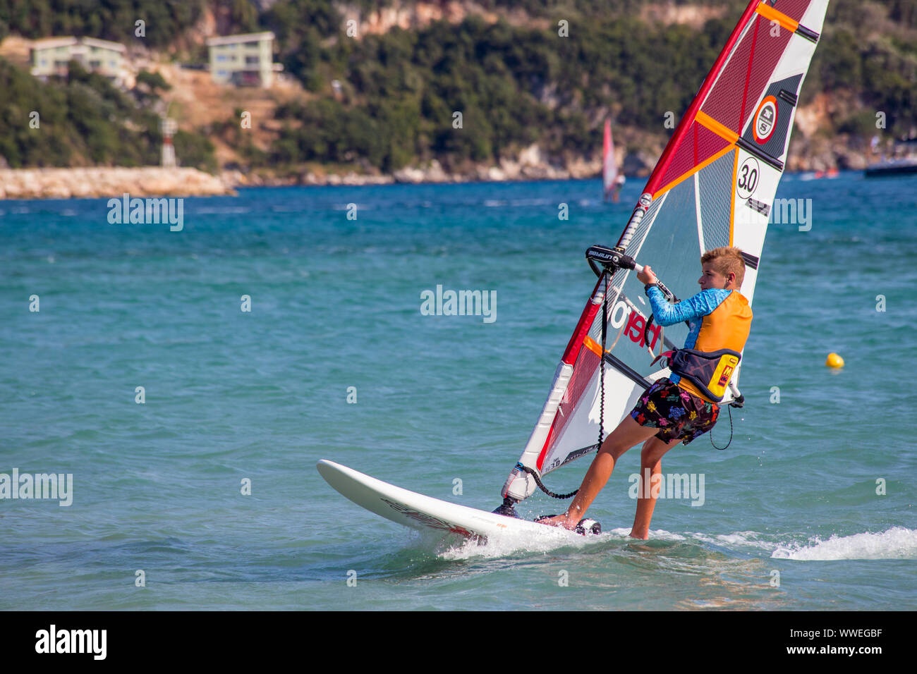 Teenage boy Learning to Windsurf at Vasiliki, Lefkada / Lefkas Island, Greece Stock Photo