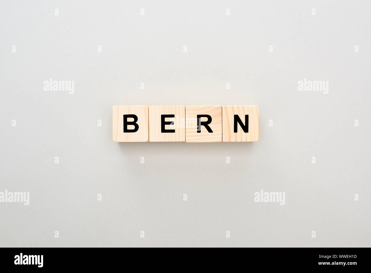top view of wooden blocks with Bern lettering on grey background Stock ...