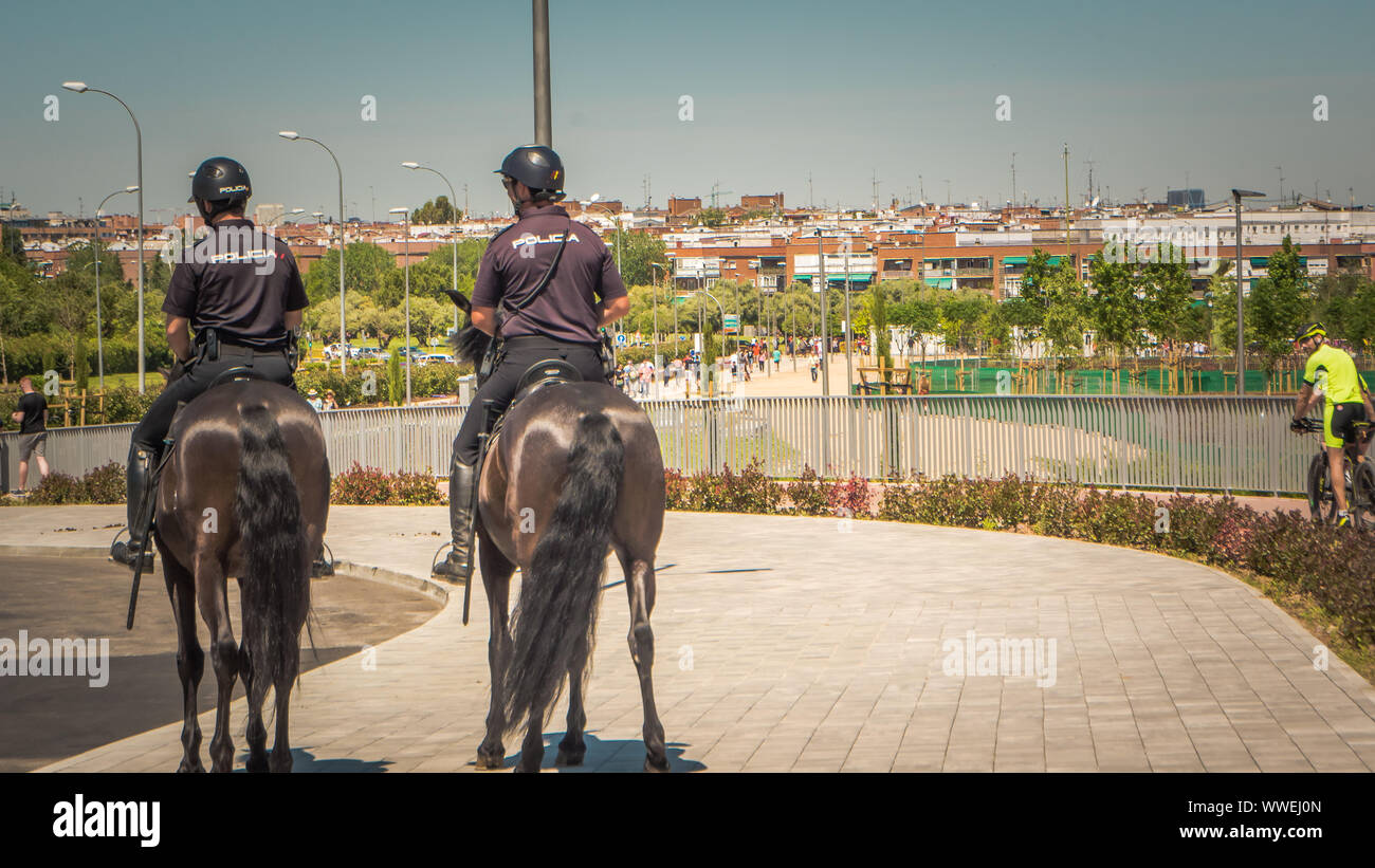 Madrid / Spain - 06 01 2019: Mounted policemen are sitting on the horseback to monitor the Wanda Metropolitano stadium in Madrid, Spain Stock Photo
