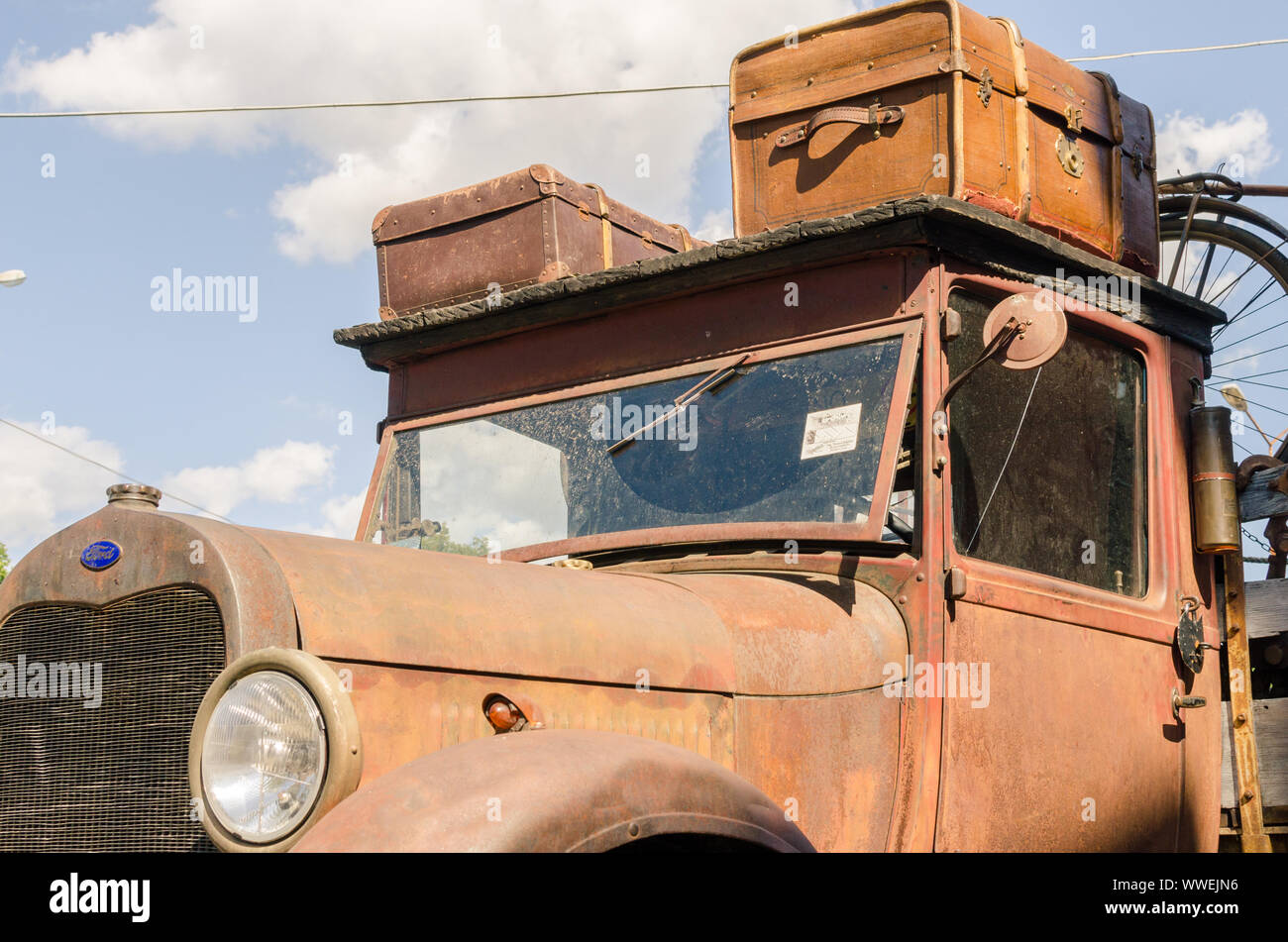 WROCLAW, POLAND - August 11, 2019: USA cars show - Old rusty Ford truck pickup 1930 - 1931-1939 with stylish vintage suitcases on the roof. Stock Photo