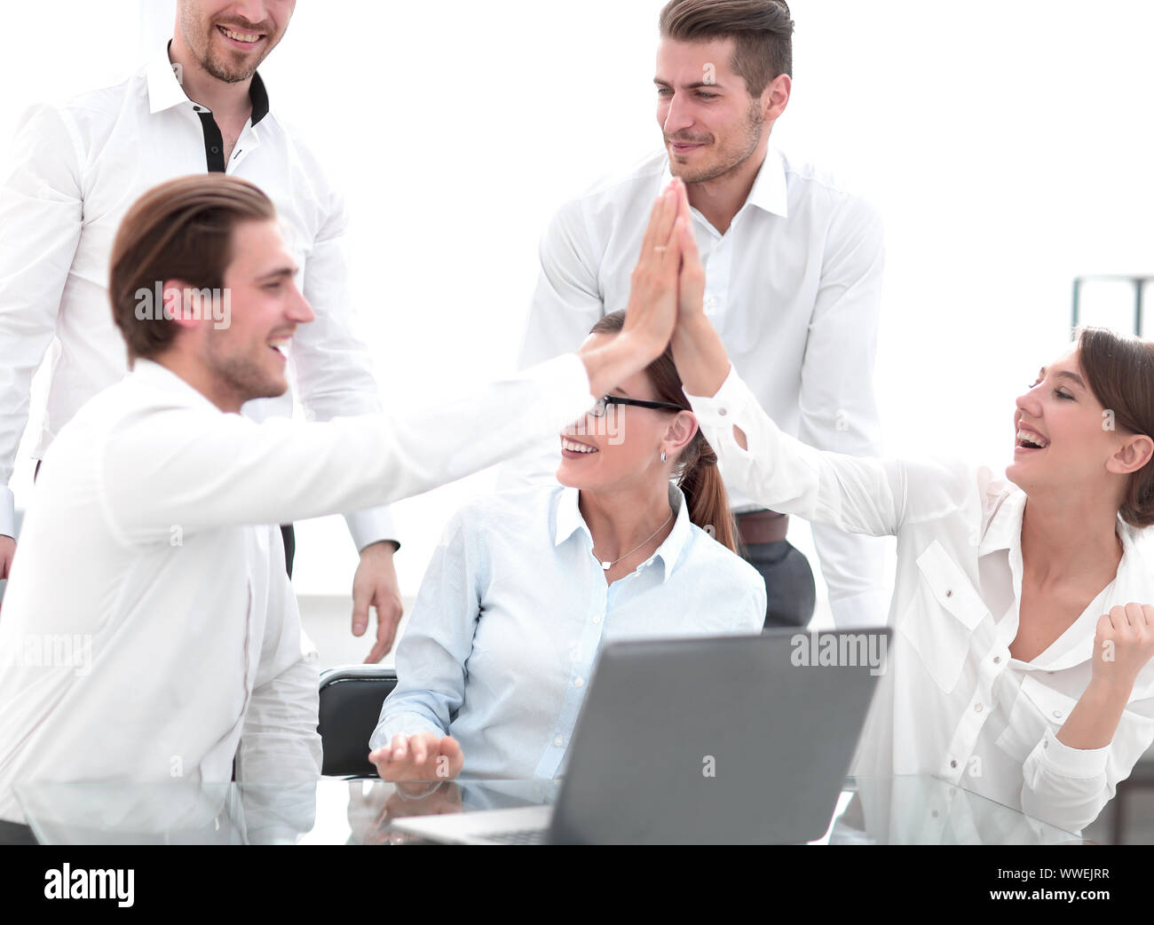 employees giving a high five at an office meeting Stock Photo - Alamy