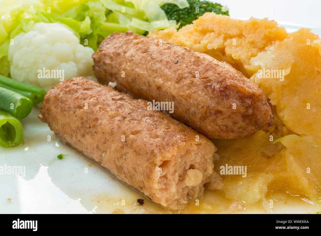 Meat free vegetarian and vegan sausages. On a plate with vegetables
