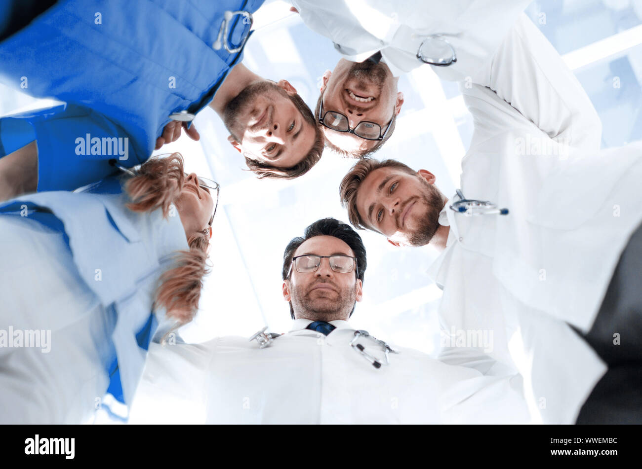 doctors looking down smiling at the camera Stock Photo - Alamy