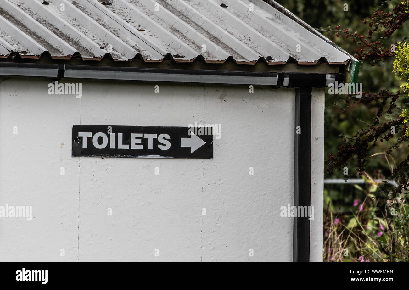 A cricket club (UK) public toilets sign on the club building. Stock Photo