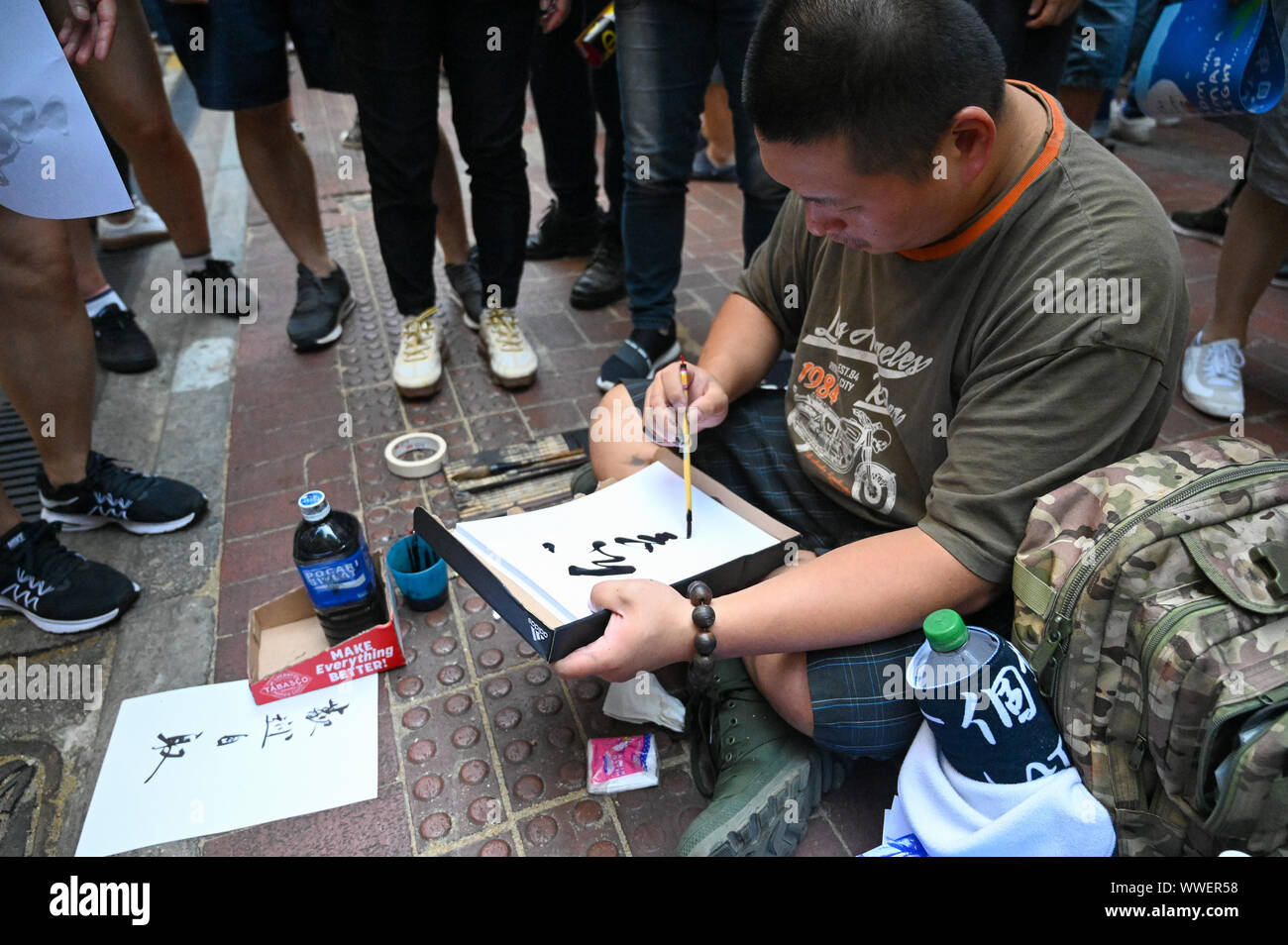 Hong Kong, Hong Kong Sar. 15th Sep, 2019. A man paints Chinese characters such as 'Justice' and 'Conscience' with calligraphy to hand out at a protest march in Hong Kong on September 15, 2019. Photo by Thomas Maresca/UPI Credit: UPI/Alamy Live News Stock Photo