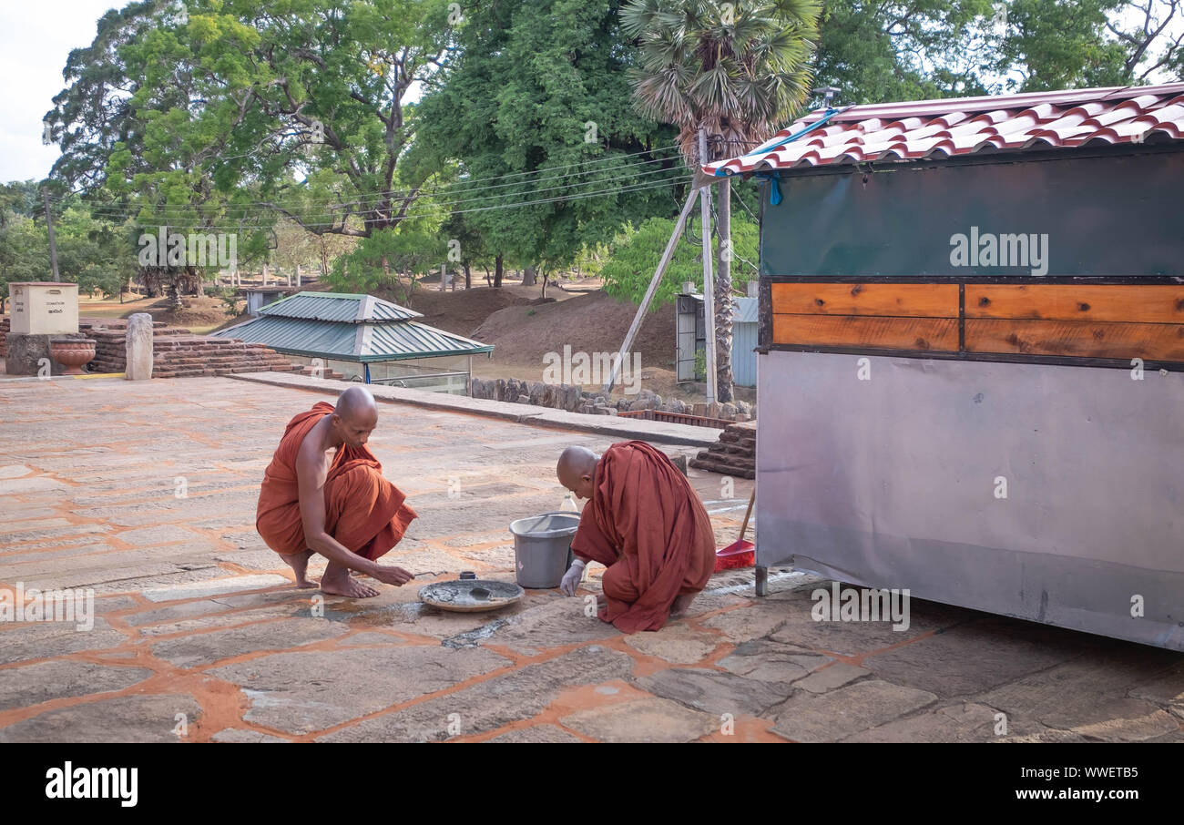 ANURADHAPURA/ SRI LANKA - AUGUST 07, 2019: The unspecific Buddhist monks in an old temple at the Stupa Ruwanweliseya located Anuradhapura, Sri Lanka. Stock Photo