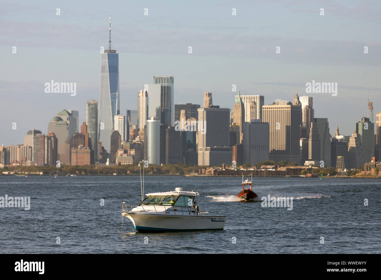Broken down boat in upper New York Bay awaiting rescue by a towboat. Stock Photo