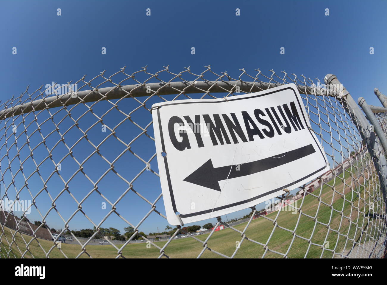 English language sign pointing to the Gymnasium in California high school in USA America Stock Photo