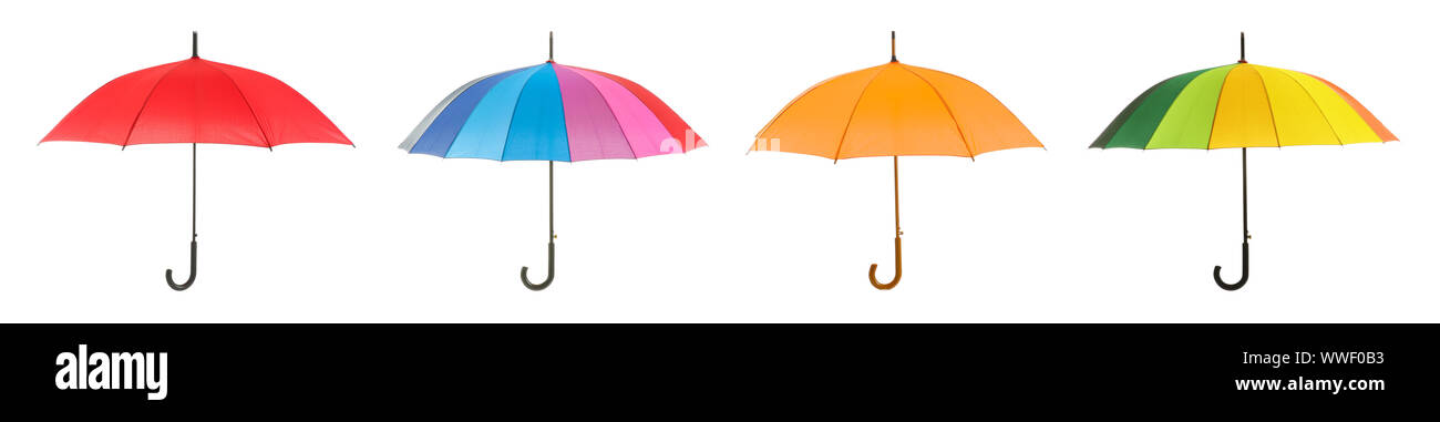 Different stylish umbrellas on white background Stock Photo
