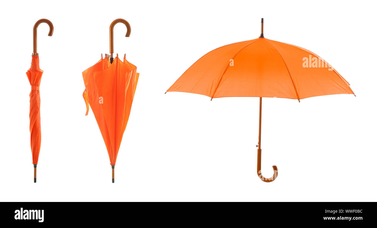 Stylish orange umbrellas on white background Stock Photo