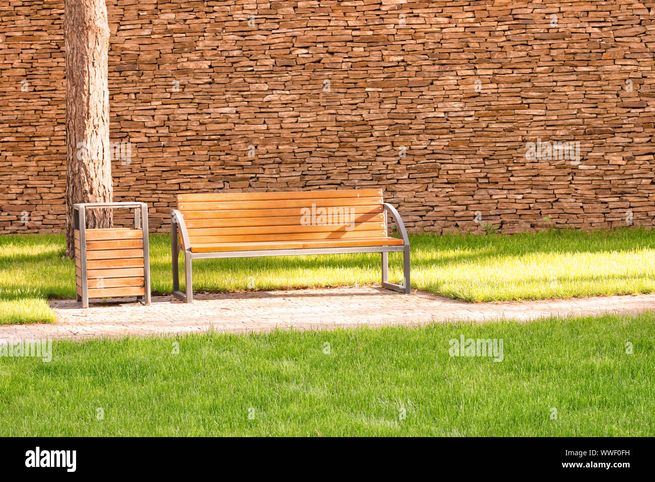 Wooden bench in city park Stock Photo - Alamy