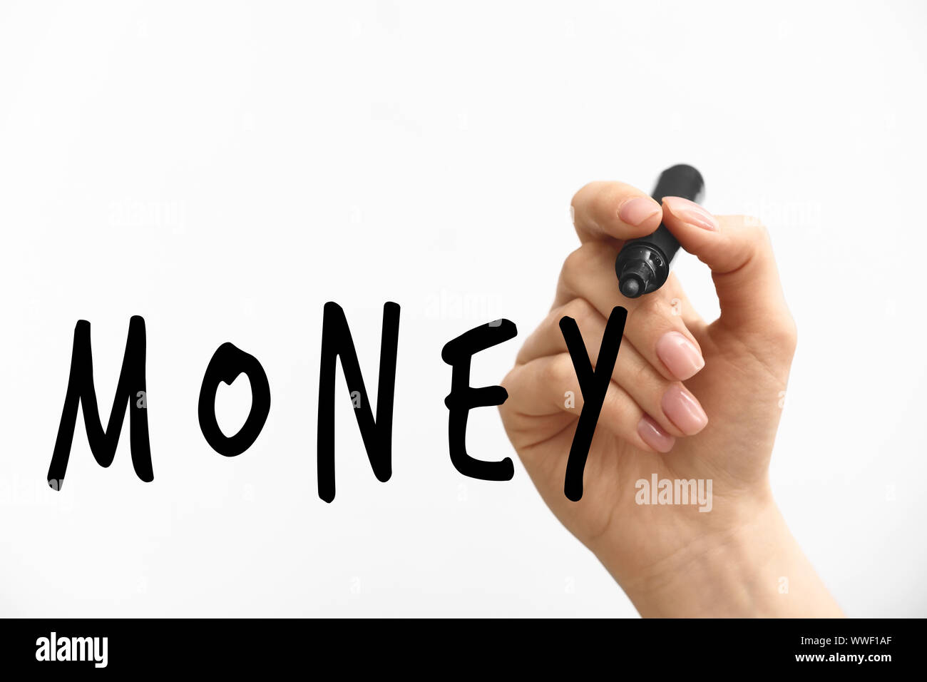 Female hand writing word MONEY on light background Stock Photo - Alamy