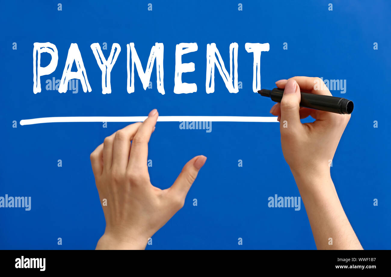 Female hands writing word PAYMENT on color background Stock Photo - Alamy