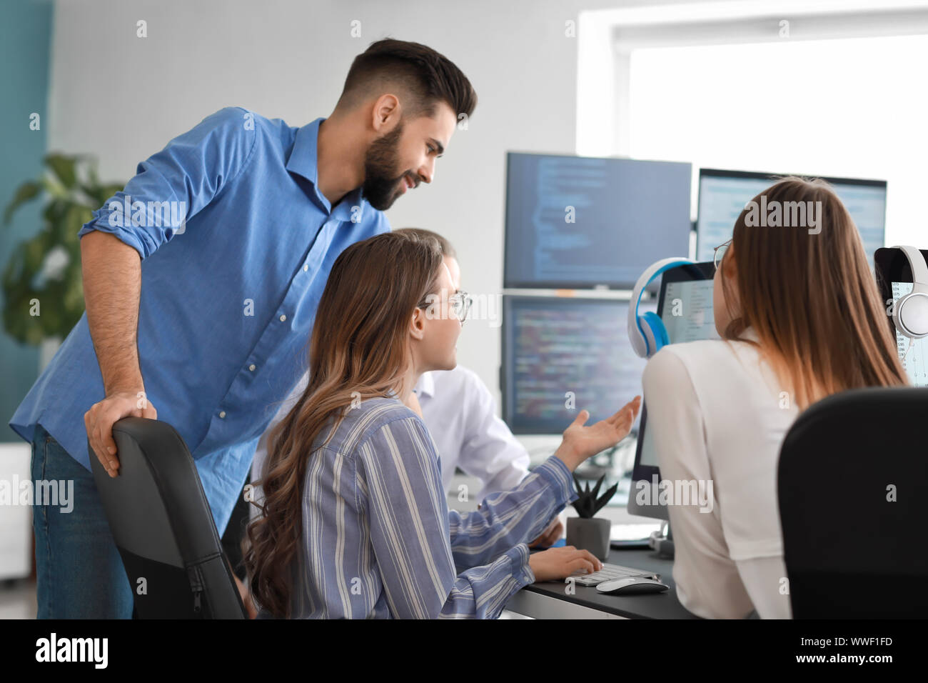Team of programmers working in office Stock Photo - Alamy