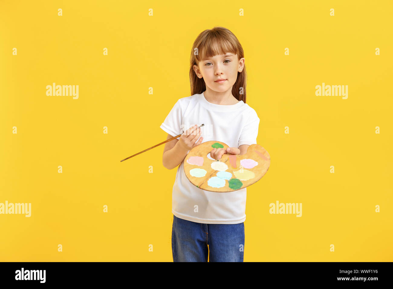 Little girl with palette and brush on color background Stock Photo - Alamy