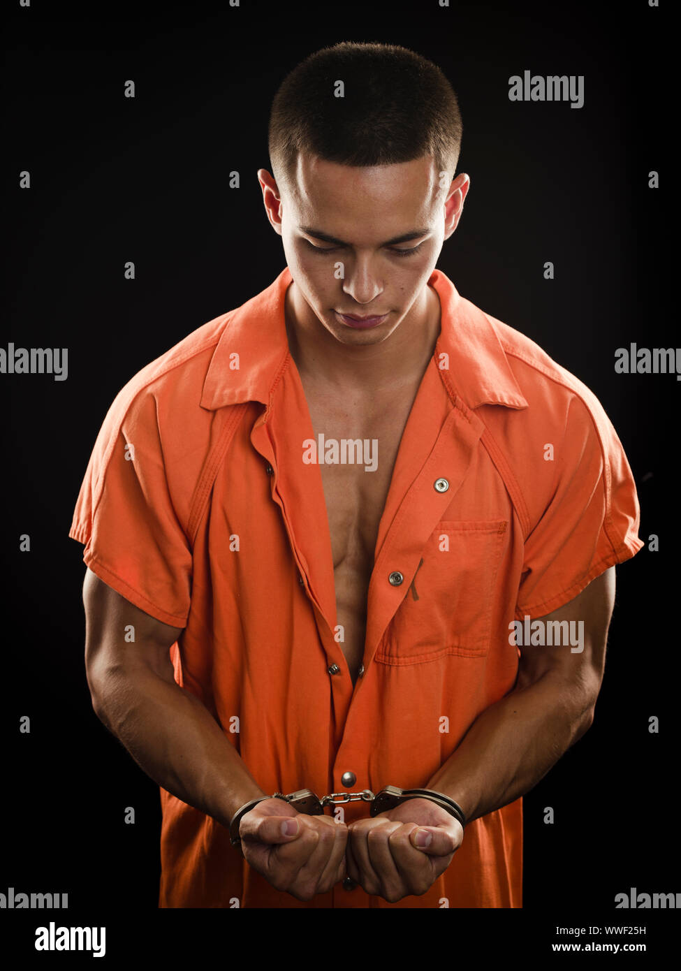 Orange prison uniform and handcuffs Stock Photo