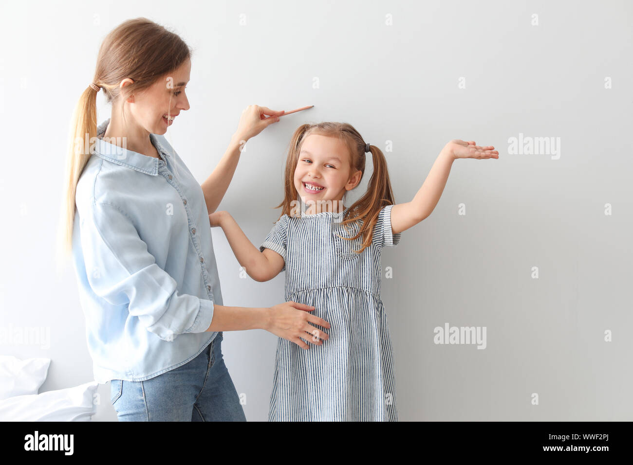 Father Measuring His Child Height With Height Measurement Stock Photo,  Picture and Royalty Free Image. Image 117855023.