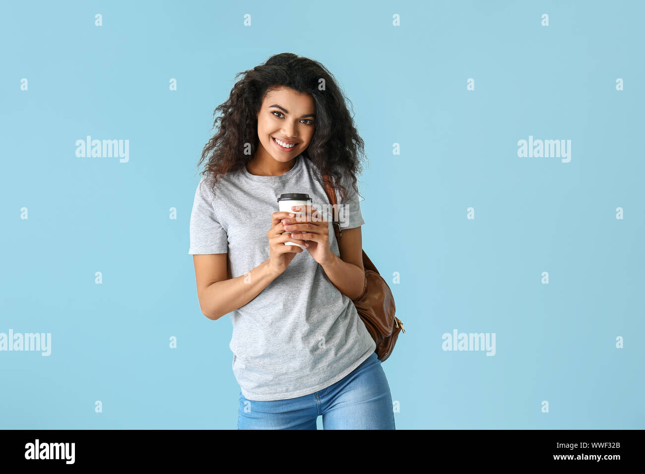 Portrait of cute African-American woman on color background Stock Photo ...