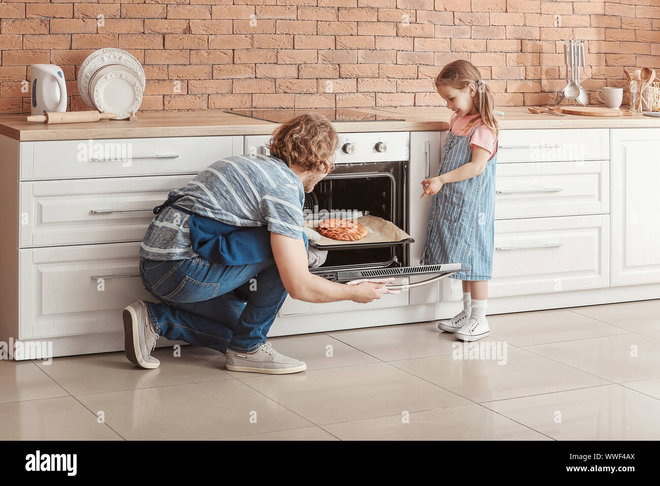 Little girl and her father baking cake in kitchen Stock Photo Alamy
