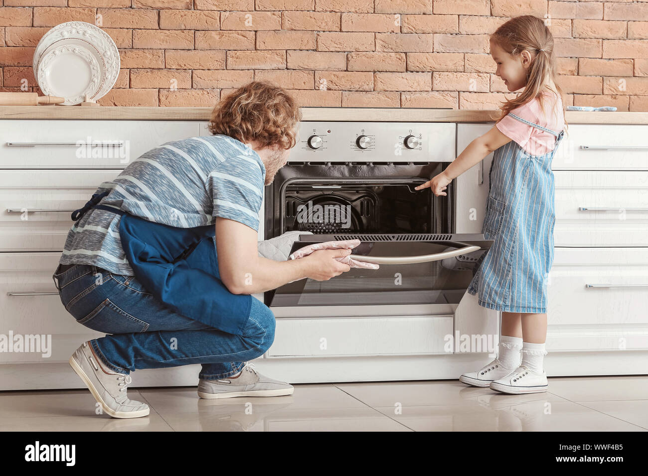 Little girl and her father baking cake in kitchen Stock Photo Alamy
