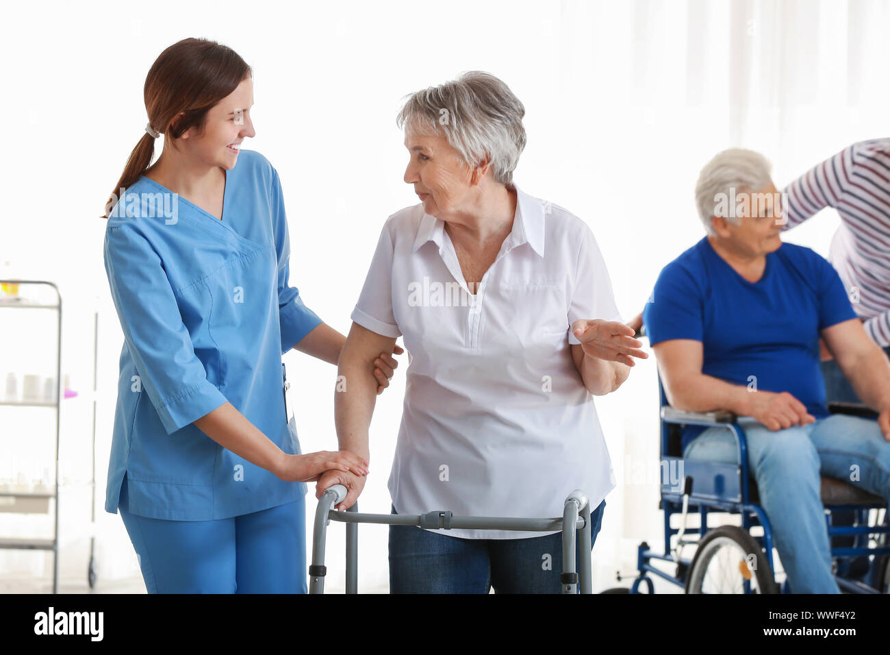 Girl looking after disabled person hires stock photography and images