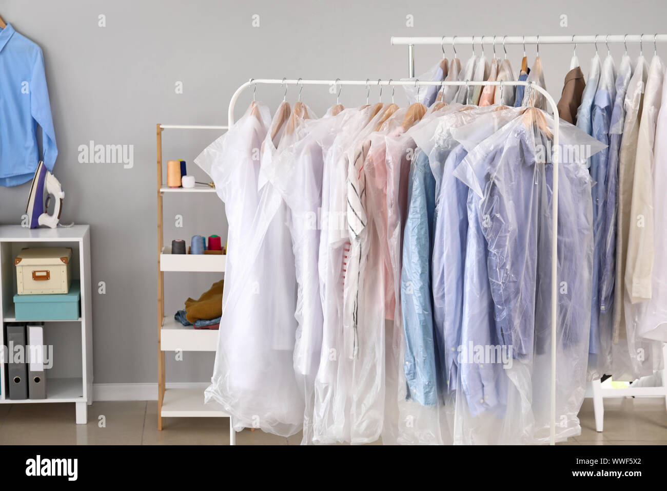 Rack with clothes in modern dry-cleaner’s Stock Photo - Alamy