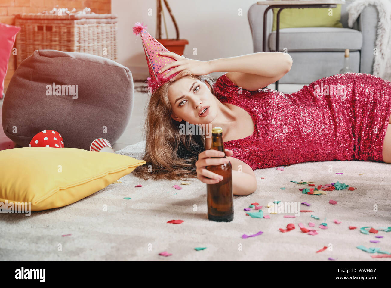 Young woman with hangover after party at home Stock Photo - Alamy