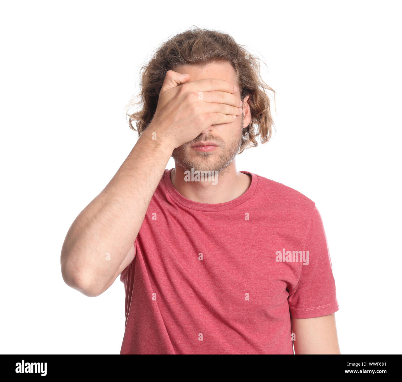 Young man covering his eyes on white background Stock Photo - Alamy