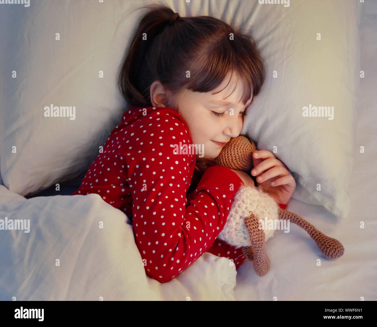 Cute little girl sleeping in bed at night Stock Photo Alamy