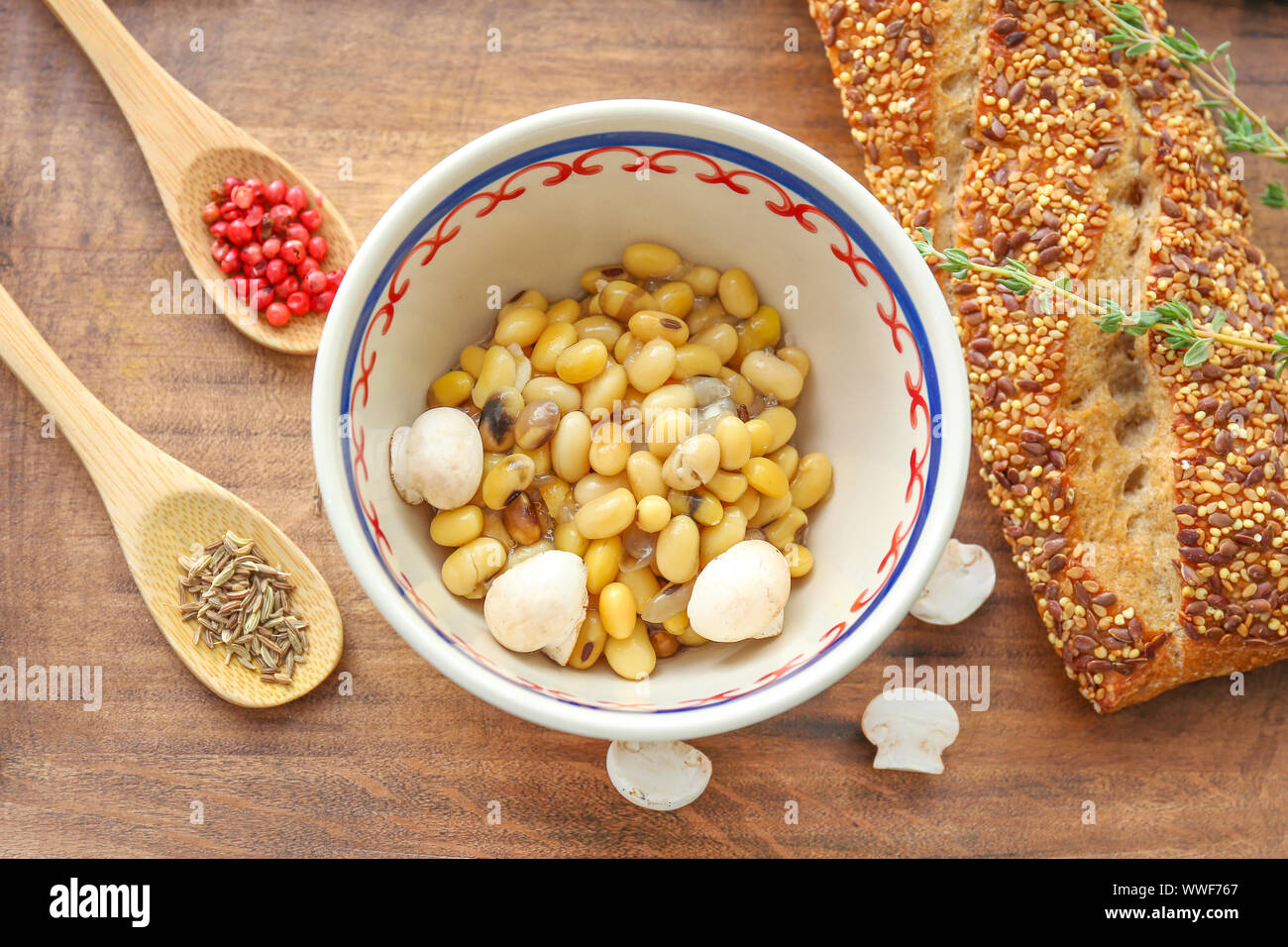Bowl with tasty boiled legumes on wooden board Stock Photo - Alamy
