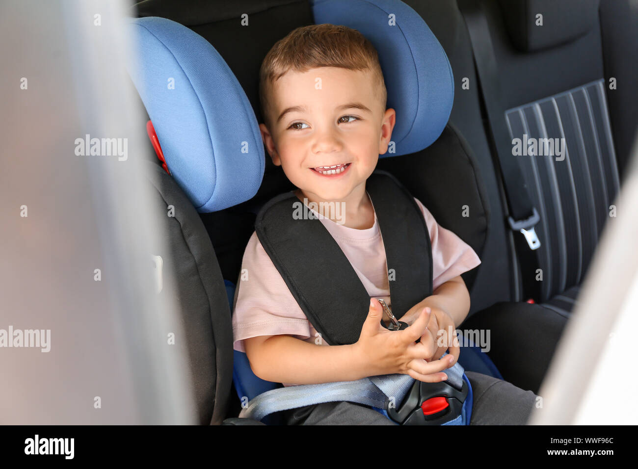 Baby boy buckled in car seat Stock Photo Alamy