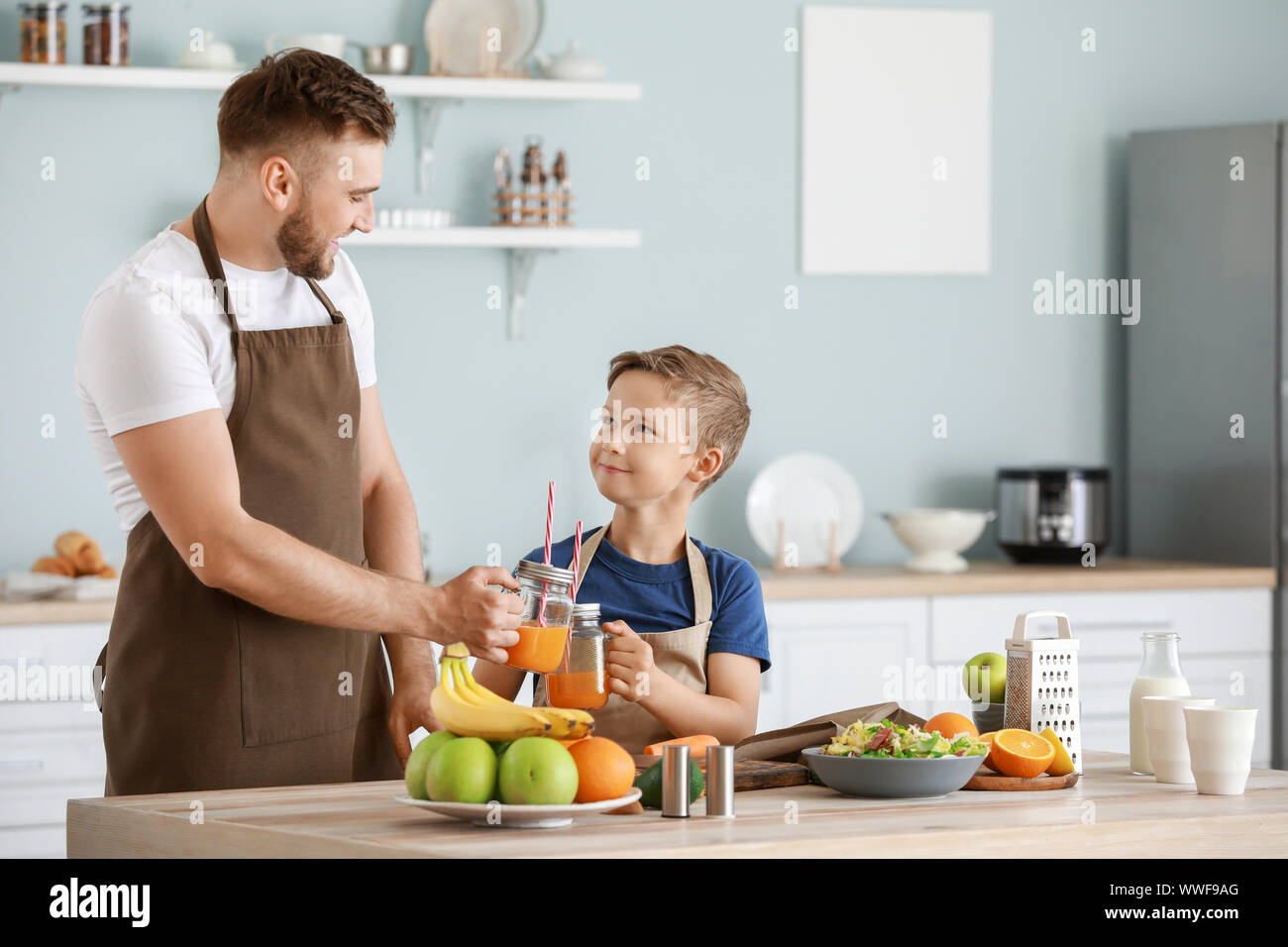 Portrait of happy father and son cooking in kitchen Stock Photo - Alamy