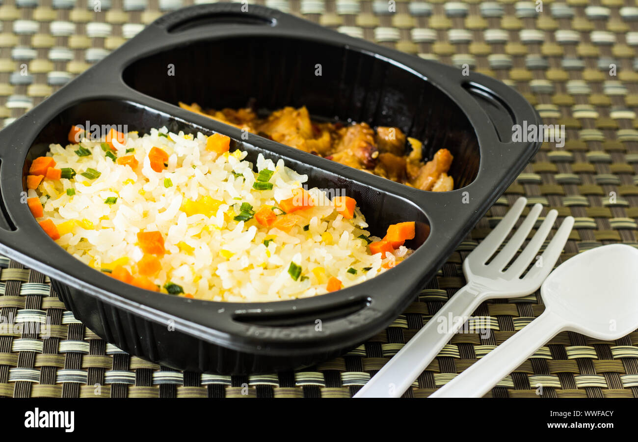 Fire rice in a lunch box with a spoon and fork Stock Photo Alamy