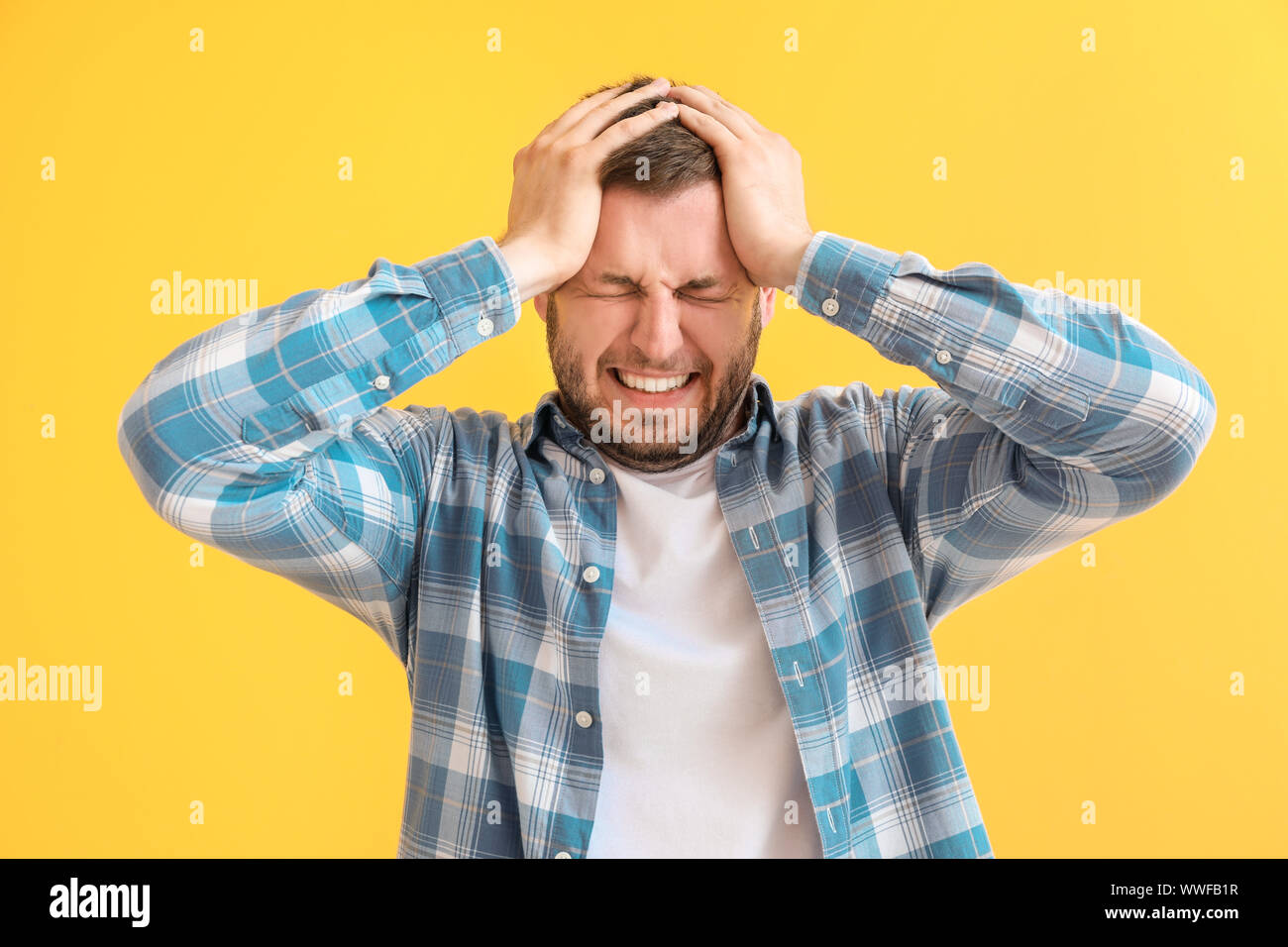 Man having panic attack on color background Stock Photo