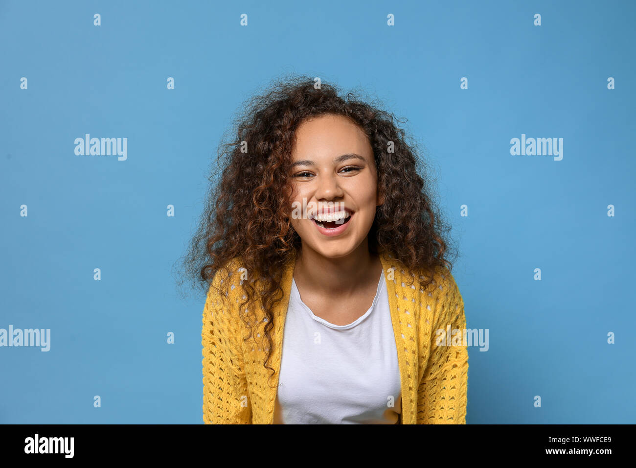 Happy African-American woman on color background Stock Photo - Alamy