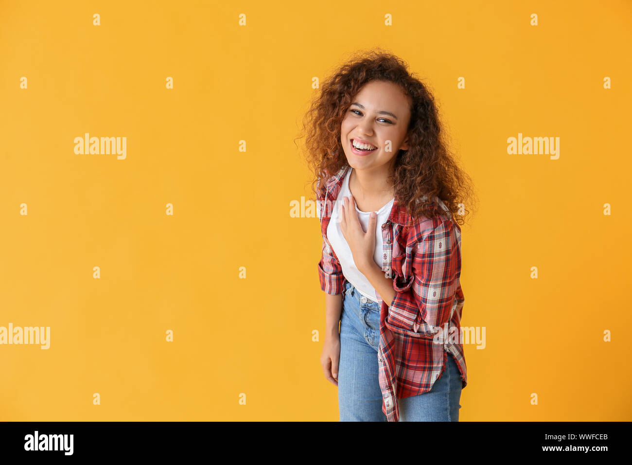 Happy African-American woman on color background Stock Photo - Alamy