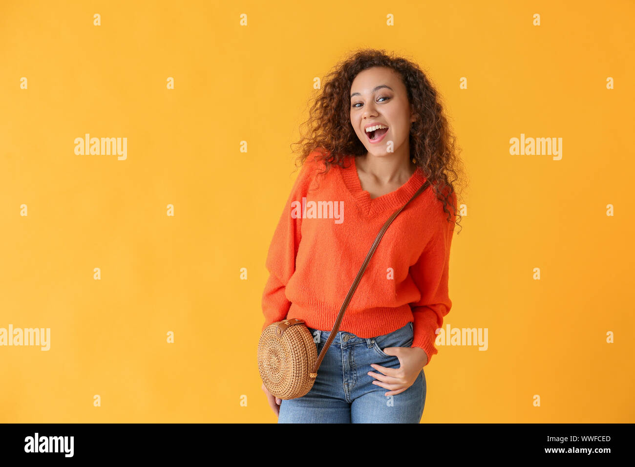 Happy African-American woman on color background Stock Photo - Alamy