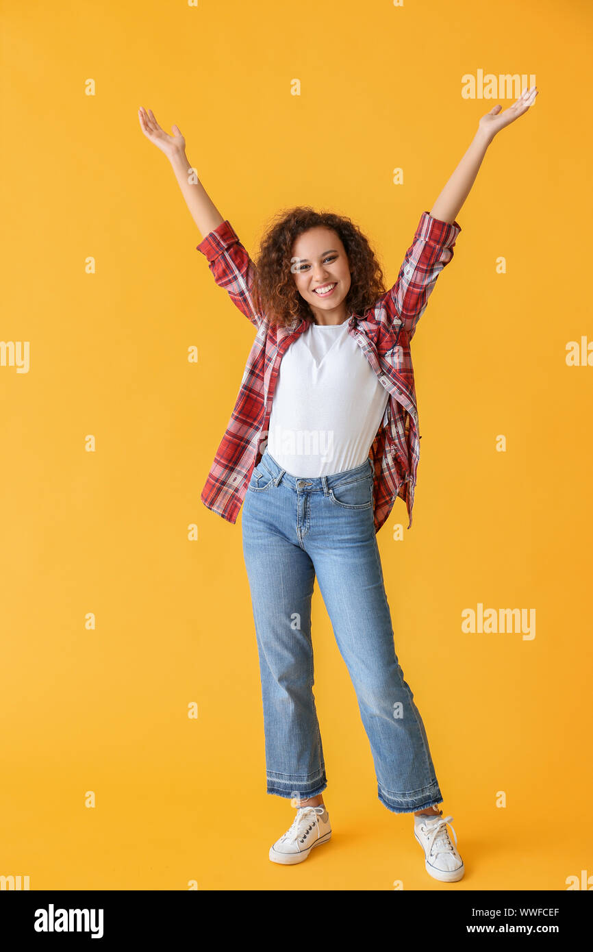 Happy African-American woman on color background Stock Photo - Alamy