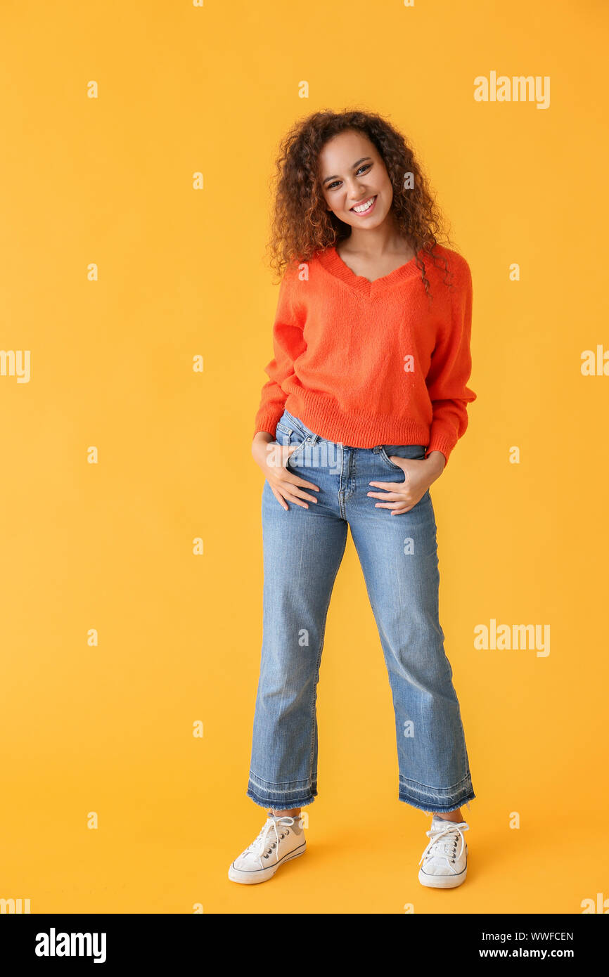 Happy African-American woman on color background Stock Photo - Alamy
