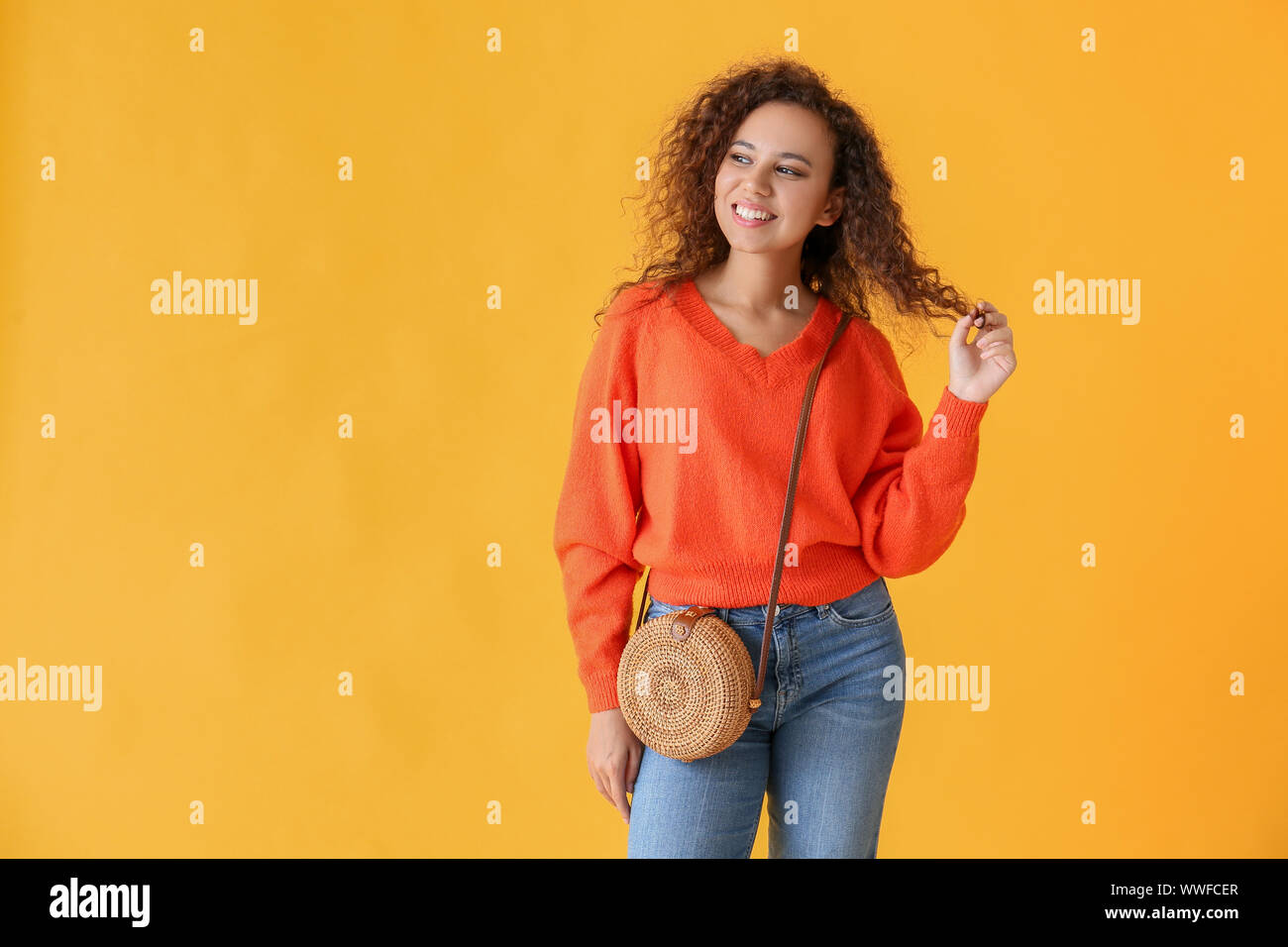 Happy African-American woman on color background Stock Photo - Alamy