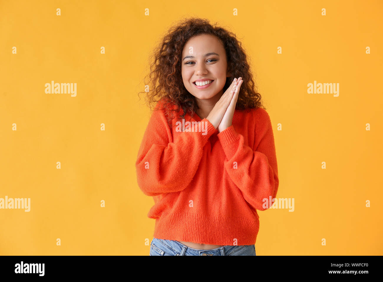 Happy African-American woman on color background Stock Photo - Alamy