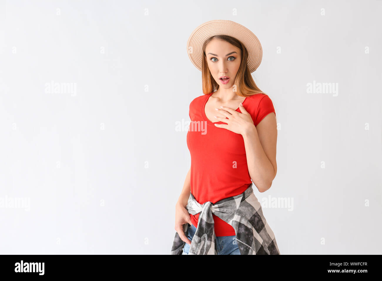 Surprised young woman on white background Stock Photo - Alamy