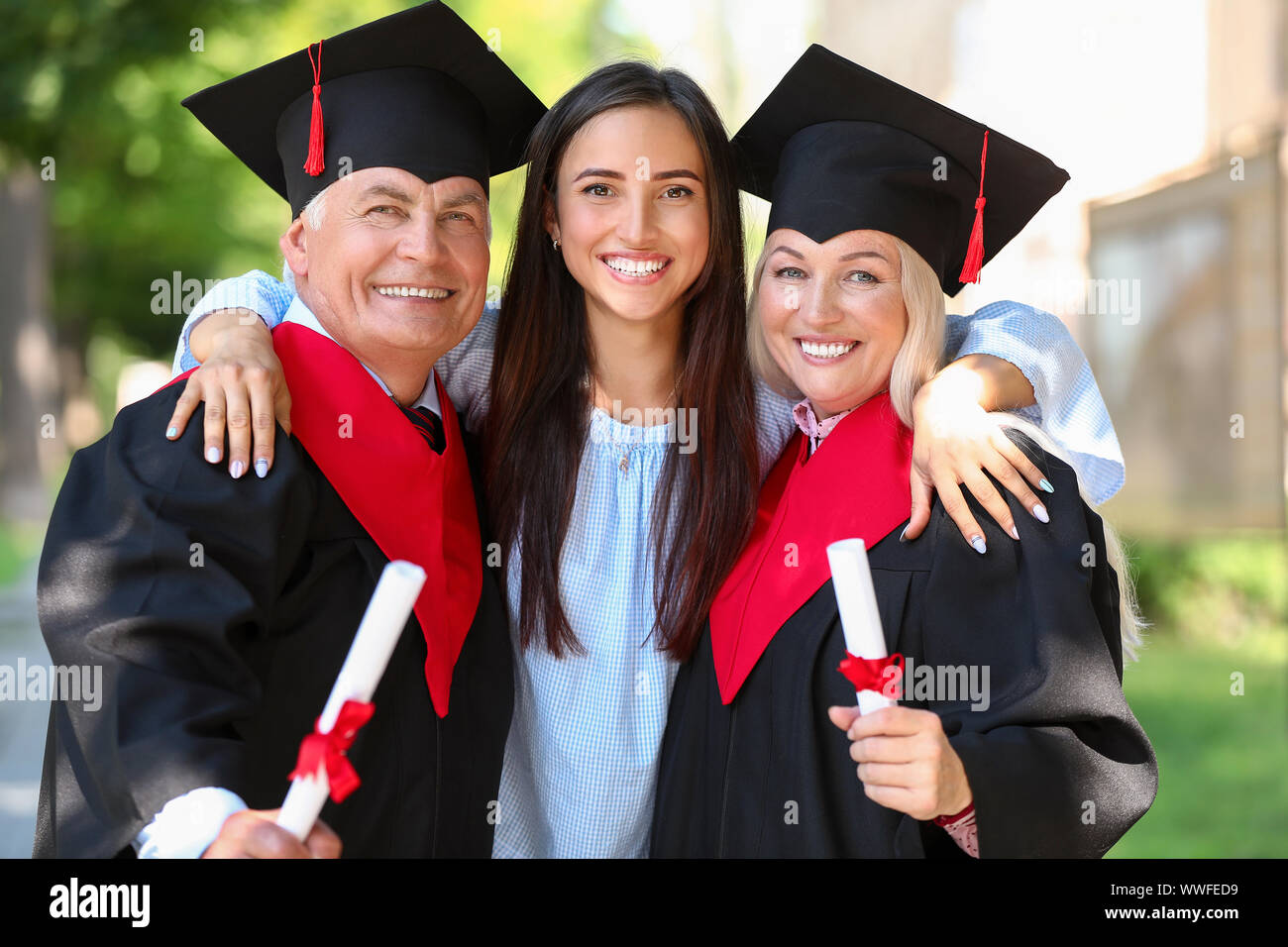 Daughter with parents on their graduation day Stock Photo Alamy