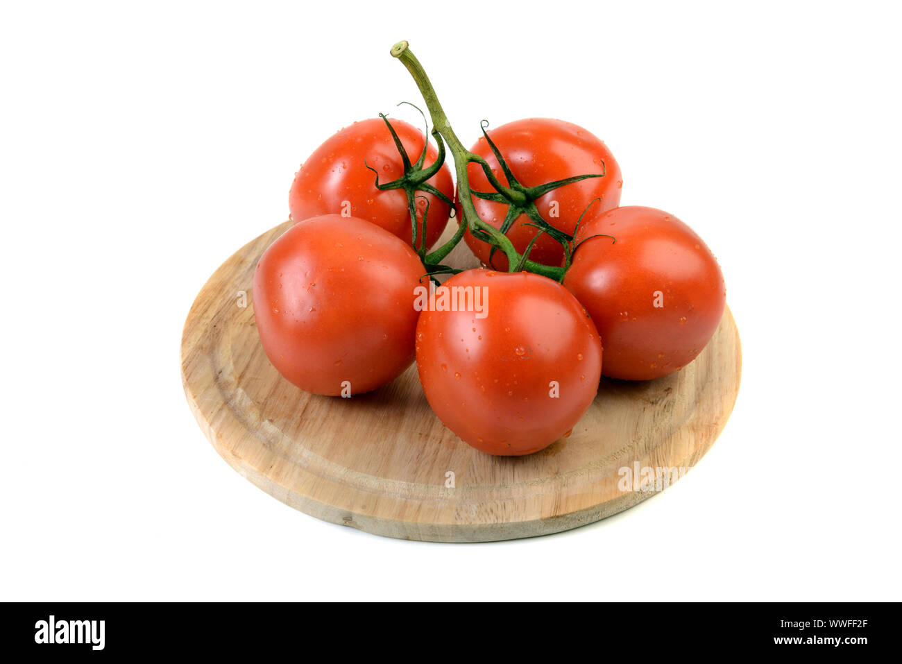 Fresh ripe cherry tomatoes on kitchen board isolated on white background Stock Photo