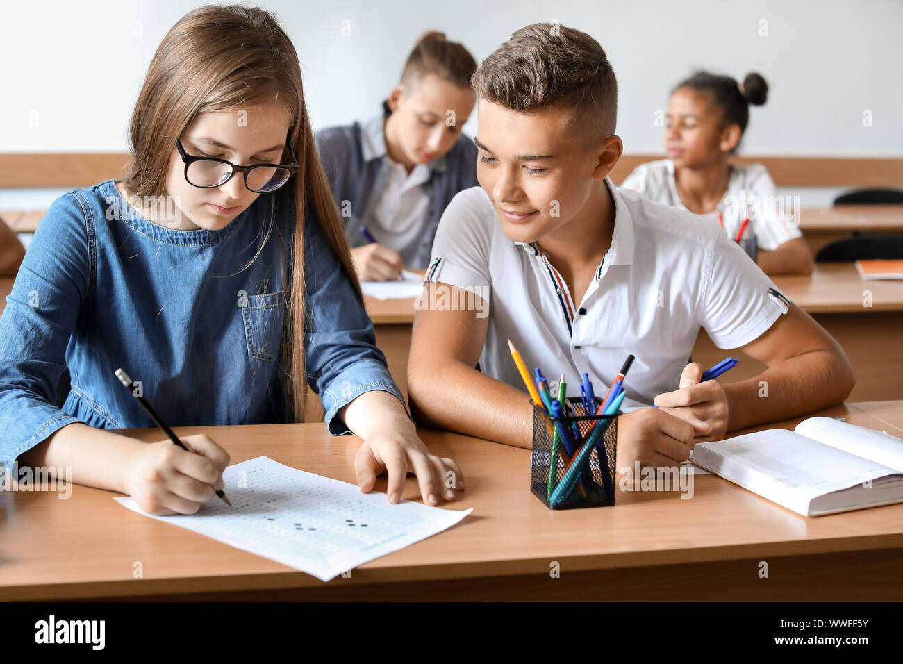 Boy cheating during school test in classroom Stock Photo Alamy