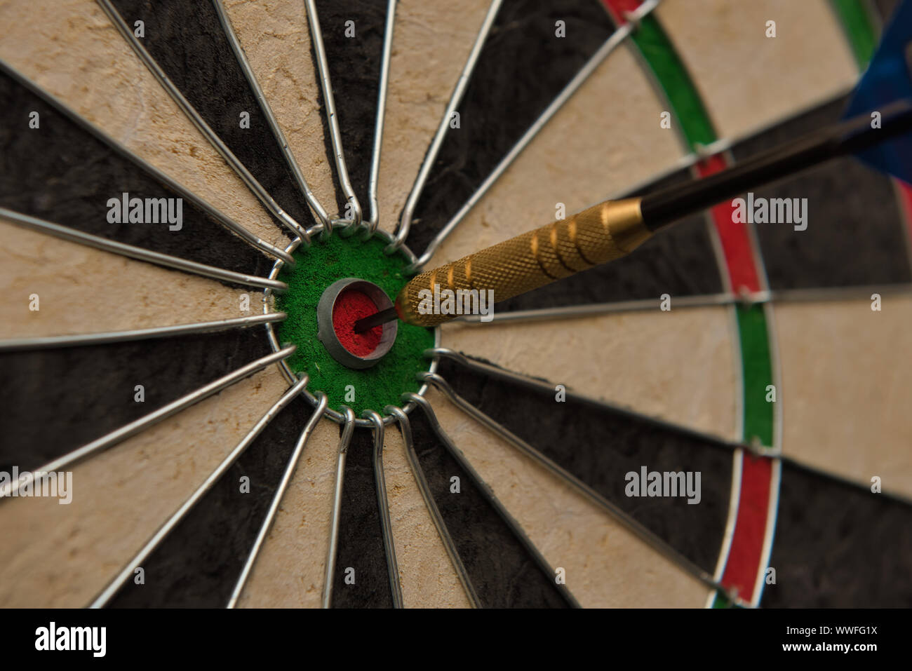A dart hits the center of the darts board also known as "bulls eye Stock  Photo - Alamy
