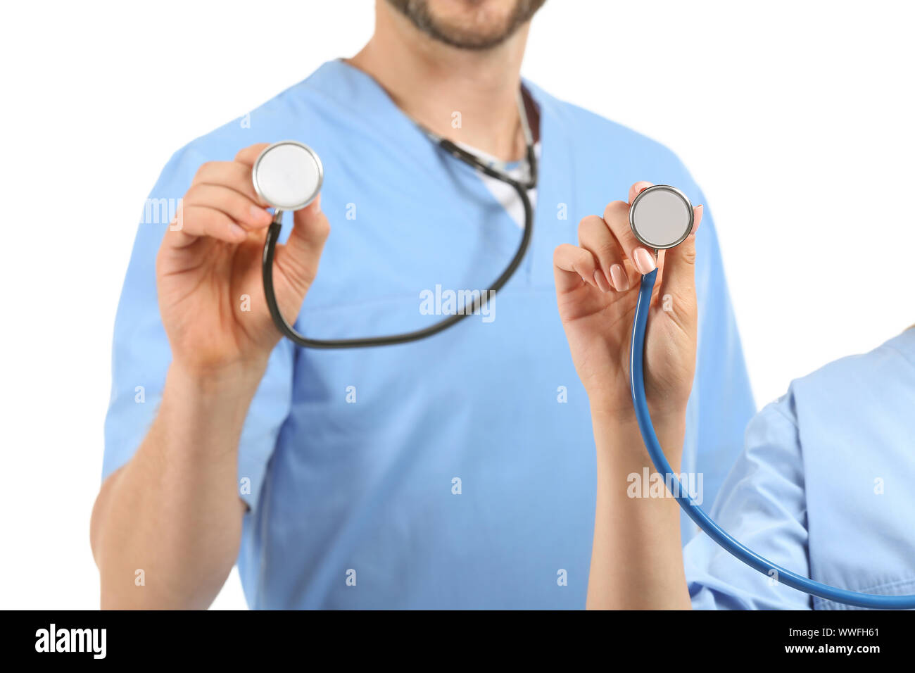 Male and female nurses with stethoscopes on white background Stock Photo Alamy