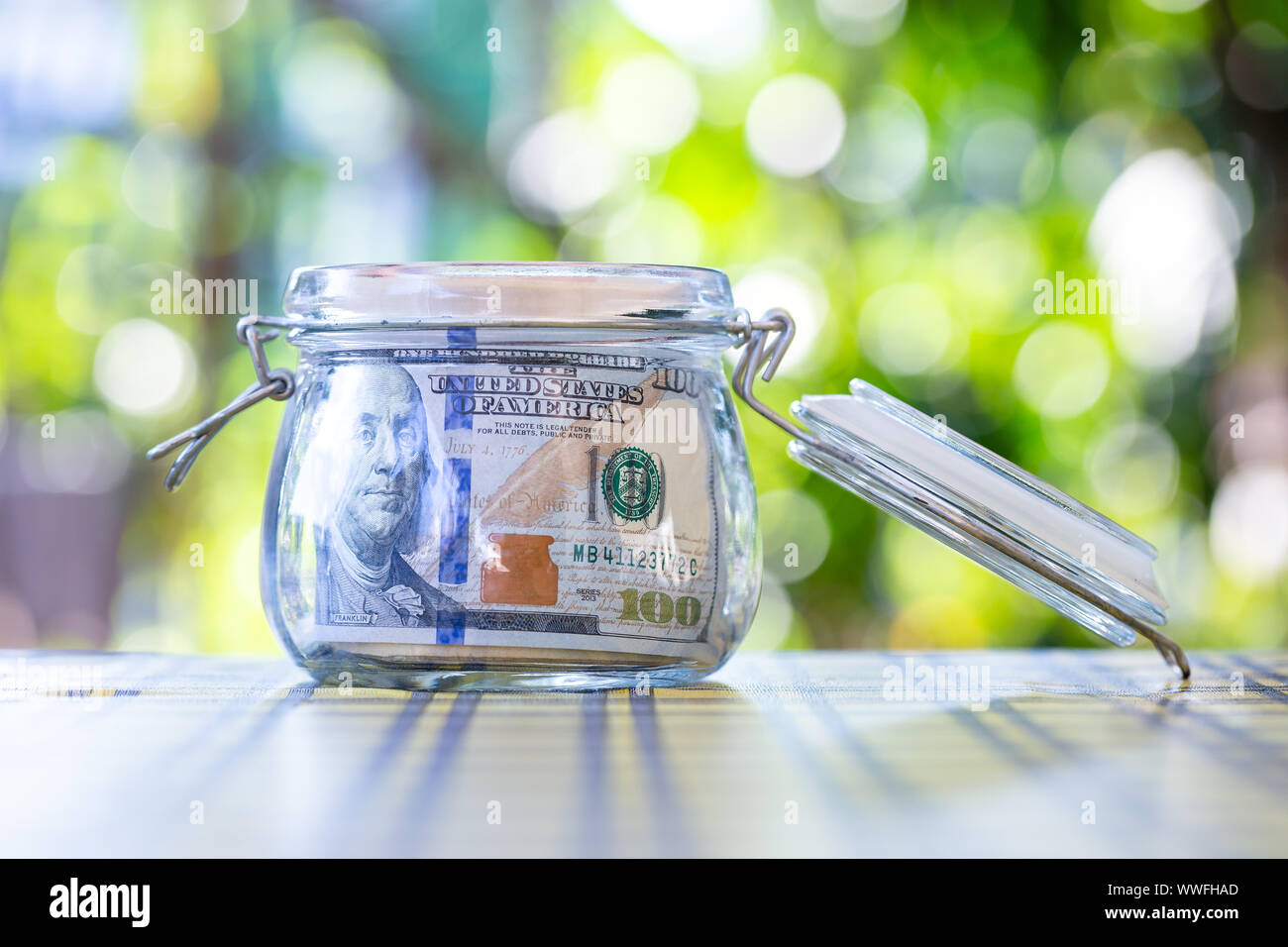 American banknote in glass jar Stock Photo - Alamy
