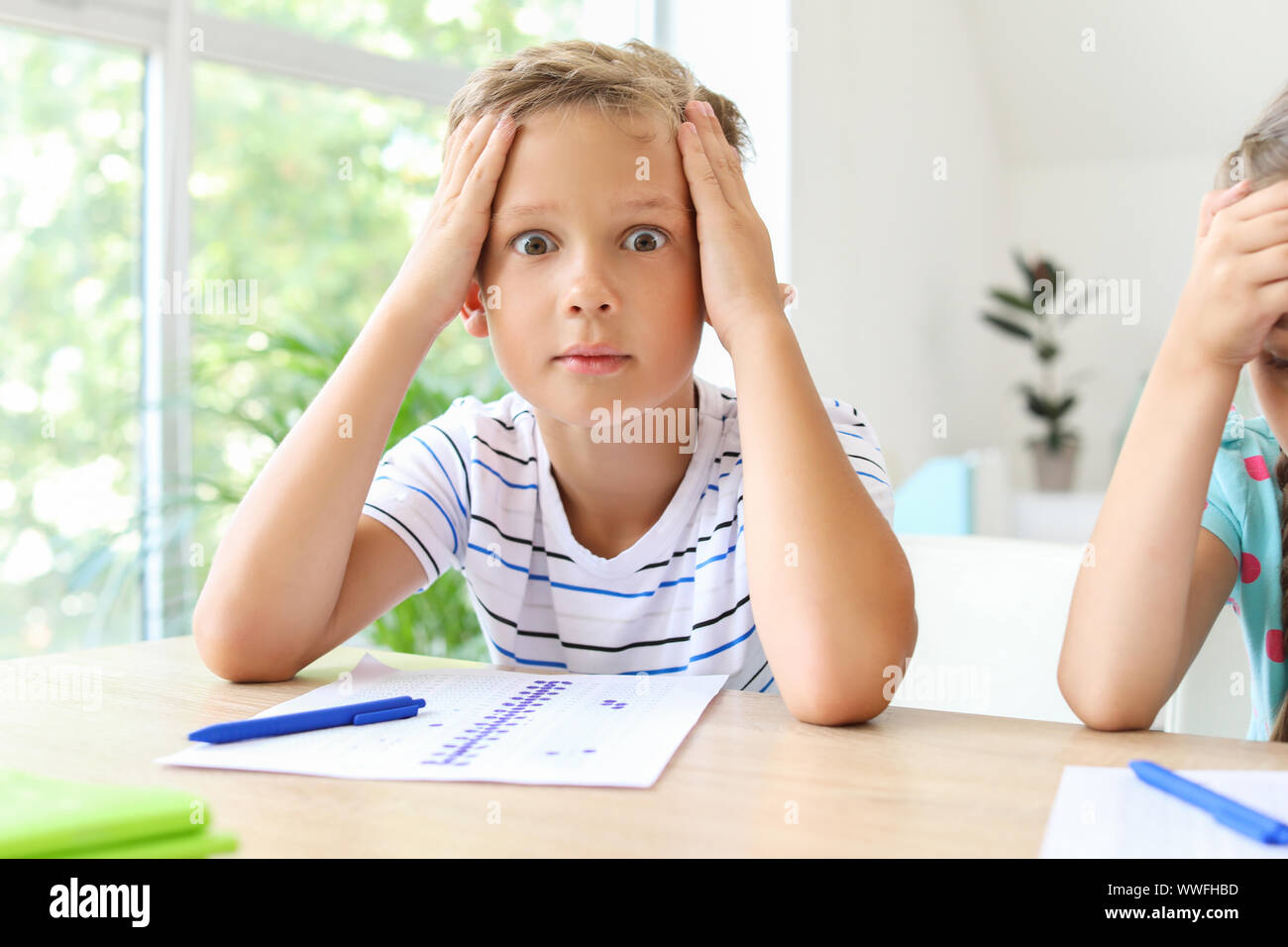 Boy passing difficult school test in classroom Stock Photo Alamy