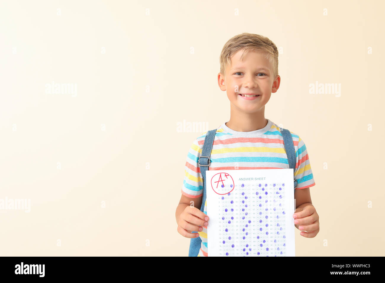 Boy Test Background Happy boy with answer sheet for school test on light background Stock ...